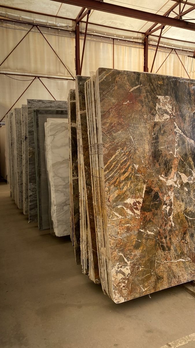 Slab bundles racked by lot number at the Royale Surfaces Dallas warehouse